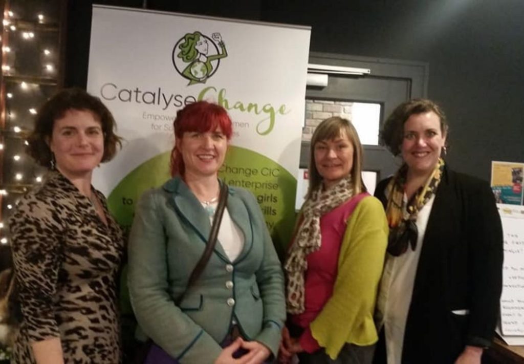 Traci with three women in front of Catalyse Change pull up banner