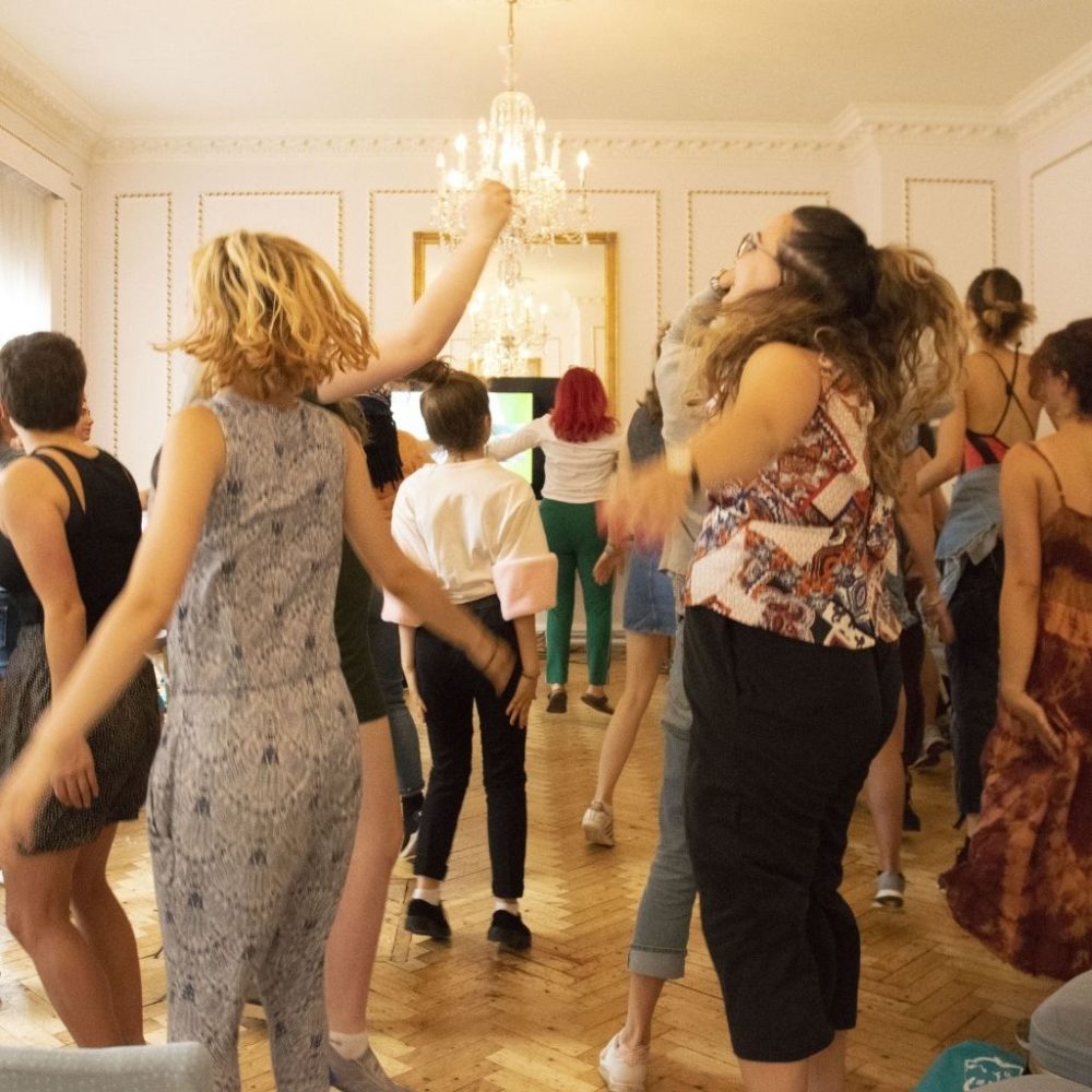 Women standing in a room dancing