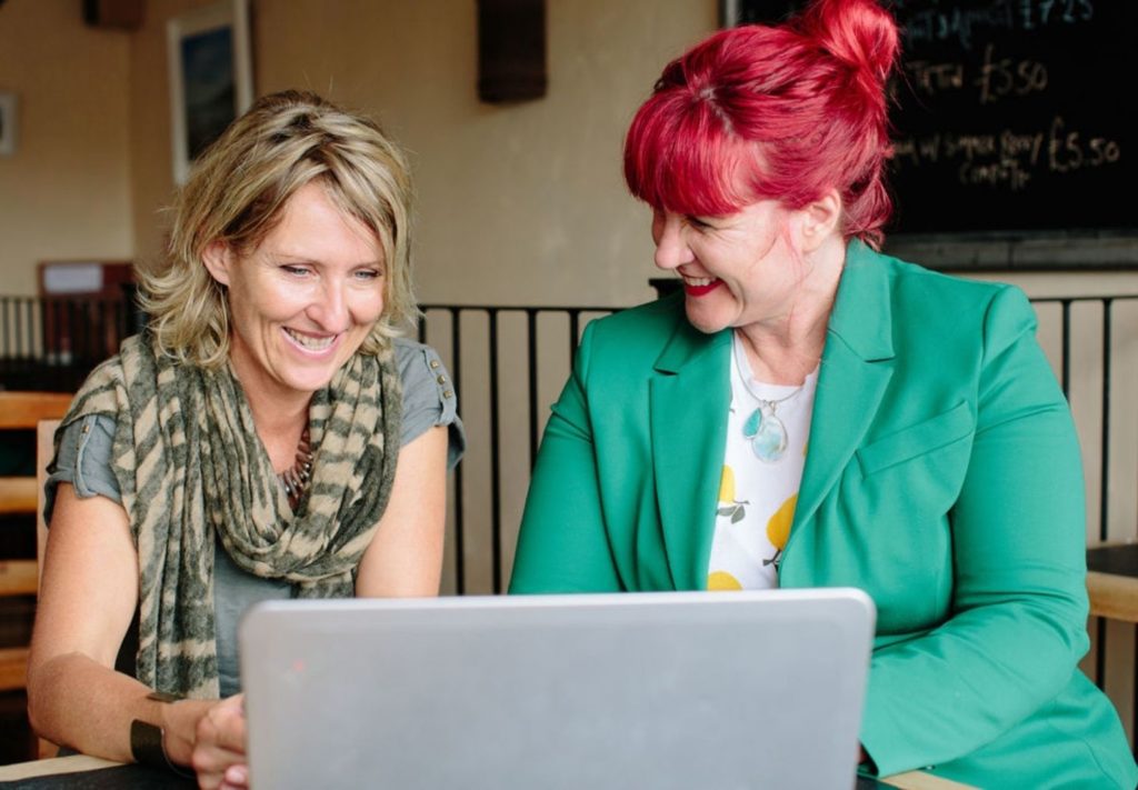 Traci and client looking at a laptop