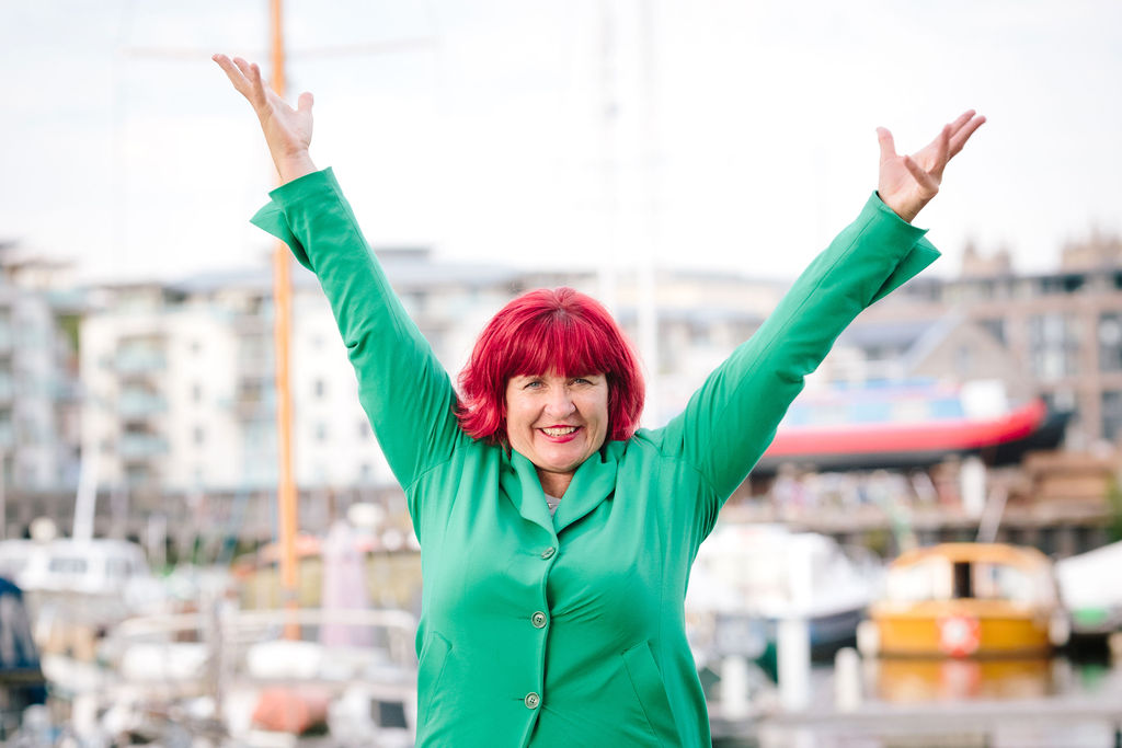 Traci posing with arms in the air at Bristol Harbour